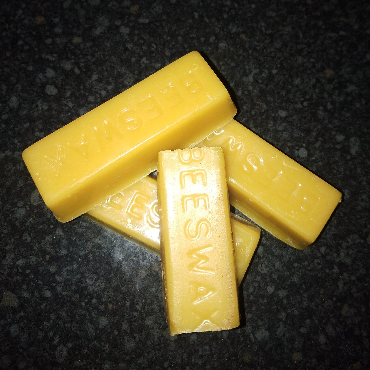 Yellow blocks of beeswax cast in moulds