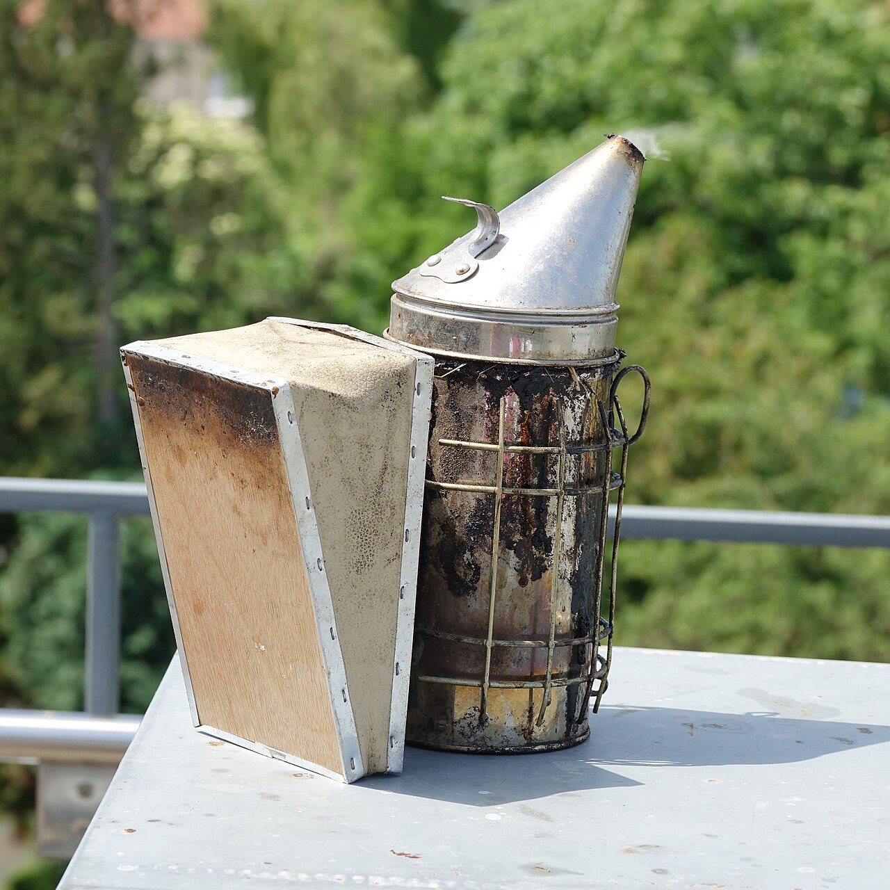Soot-covered beekeeping smoker
